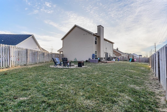 rear view of house with a lawn and a patio area