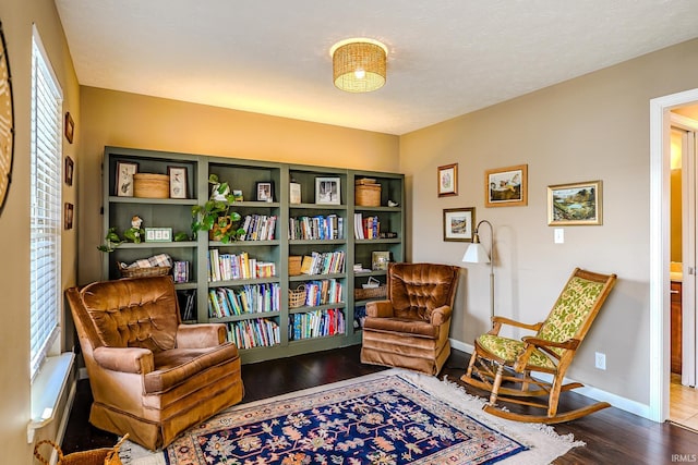 living area with hardwood / wood-style flooring