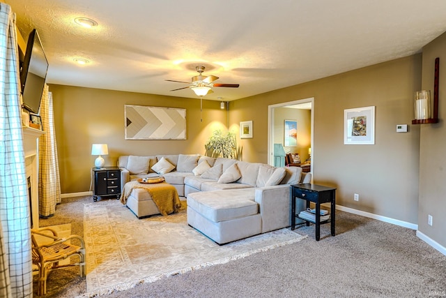 carpeted living room with a textured ceiling and ceiling fan