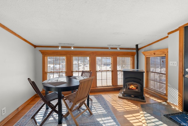 dining space with crown molding, rail lighting, and a textured ceiling