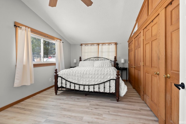 bedroom featuring lofted ceiling, ceiling fan, and light wood-type flooring