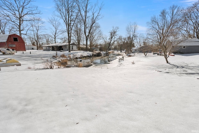 yard covered in snow with an outdoor structure