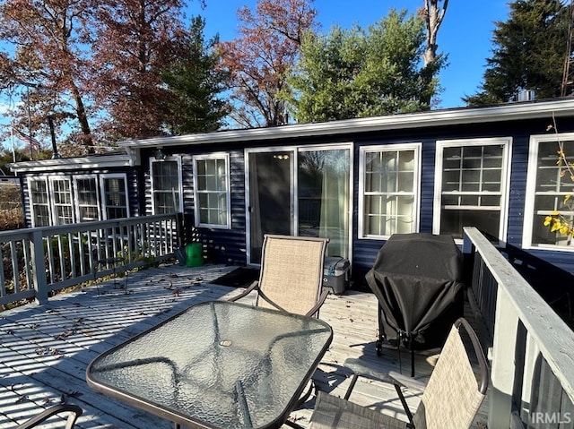 wooden deck with a grill