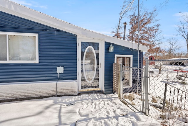 view of snow covered property entrance