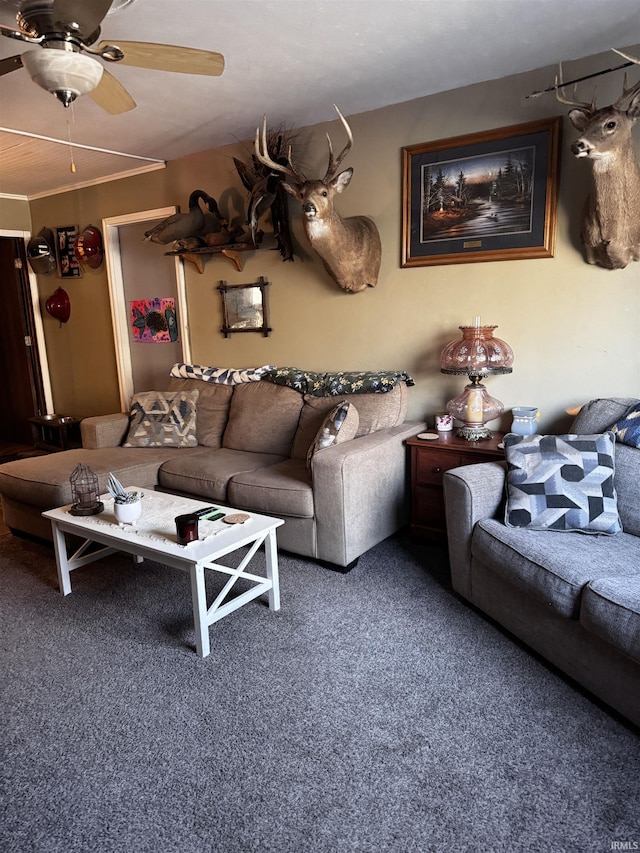 living room with crown molding, ceiling fan, and carpet