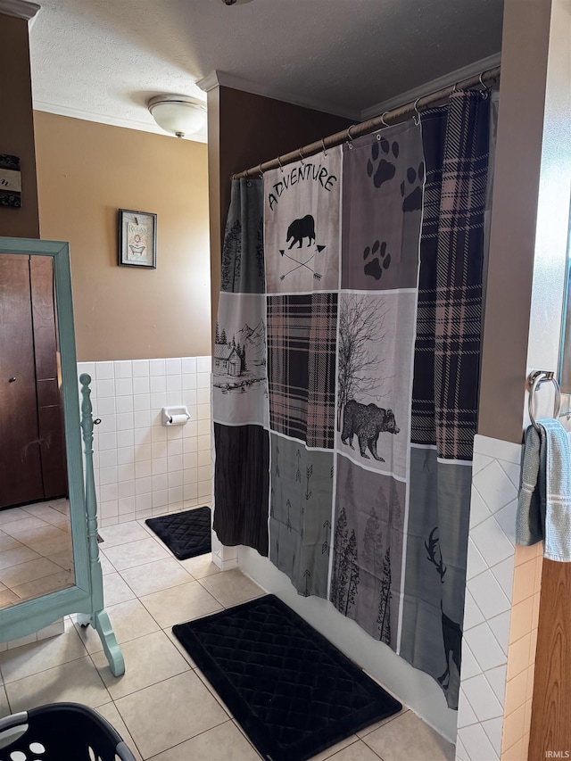 bathroom with tile walls, tile patterned flooring, a textured ceiling, and a shower with shower curtain