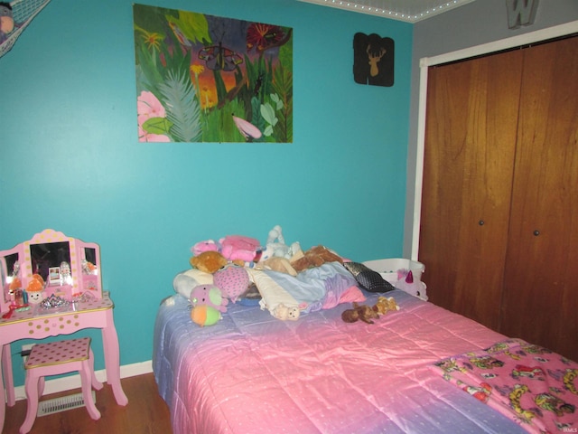 bedroom featuring wood-type flooring and a closet