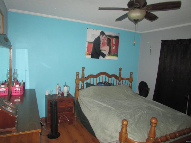 bedroom featuring crown molding, ceiling fan, and hardwood / wood-style flooring