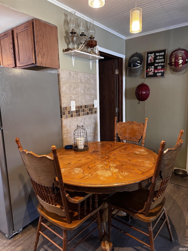 dining room featuring ornamental molding and wood-type flooring