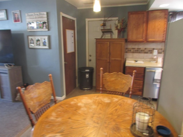 carpeted dining room with crown molding