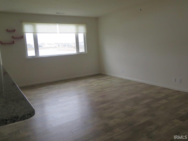 unfurnished room with hardwood / wood-style flooring