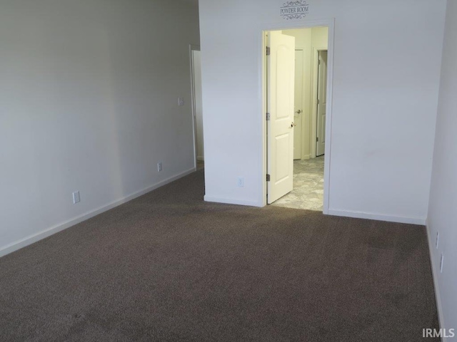 spare room featuring light carpet