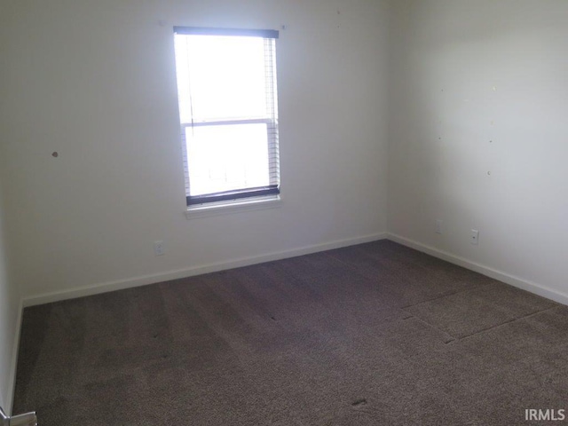 carpeted spare room featuring plenty of natural light