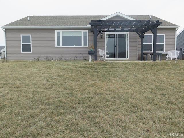 rear view of property featuring a lawn and a pergola