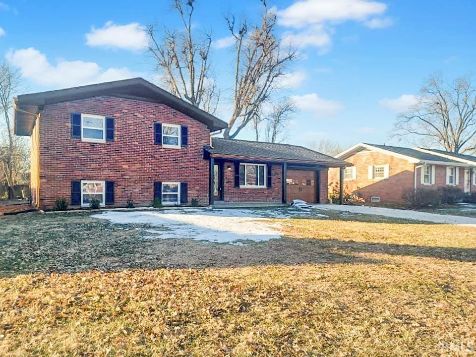 exterior space featuring a garage and a front lawn