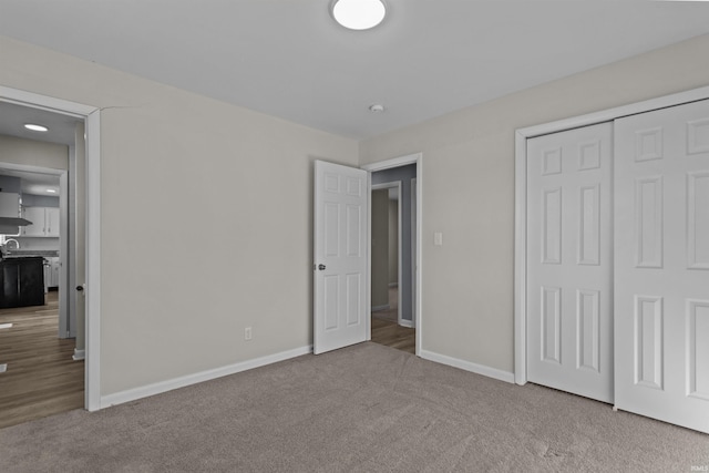 unfurnished bedroom with carpet floors and a closet