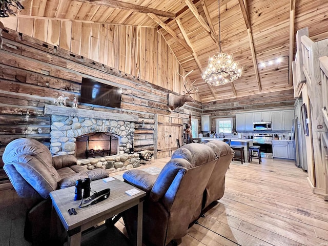 living room featuring wood ceiling, beam ceiling, high vaulted ceiling, log walls, and light wood-type flooring