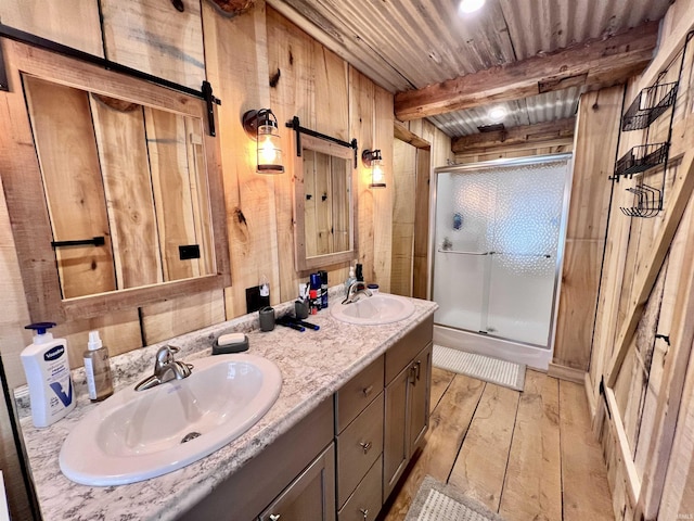 bathroom with hardwood / wood-style floors, wooden walls, an enclosed shower, wooden ceiling, and beam ceiling