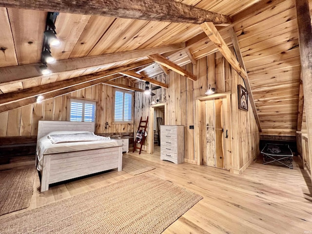 unfurnished bedroom featuring wood ceiling, vaulted ceiling with beams, light hardwood / wood-style flooring, and wood walls