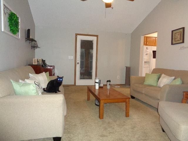 living room featuring ceiling fan, lofted ceiling, and light carpet