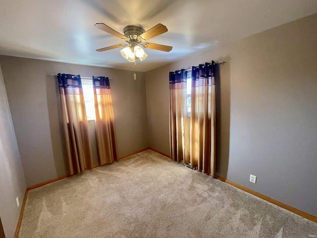 carpeted empty room with ceiling fan