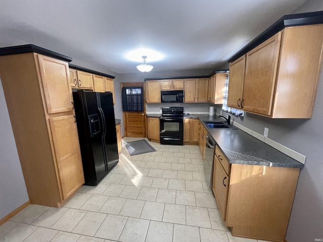 kitchen with light tile patterned flooring, sink, and black appliances