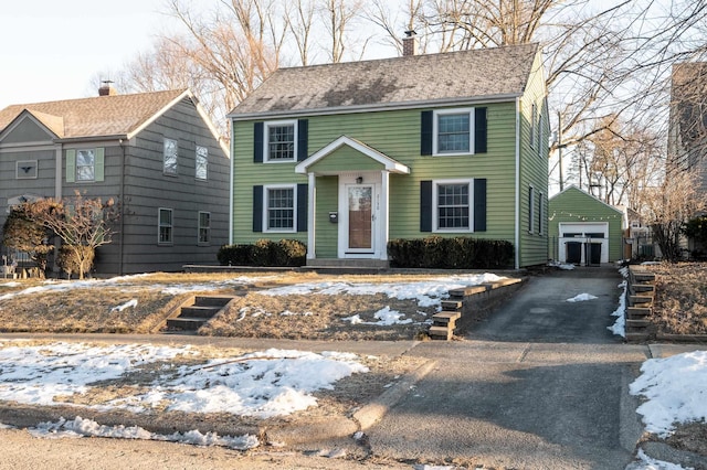 colonial home with an outbuilding and a garage