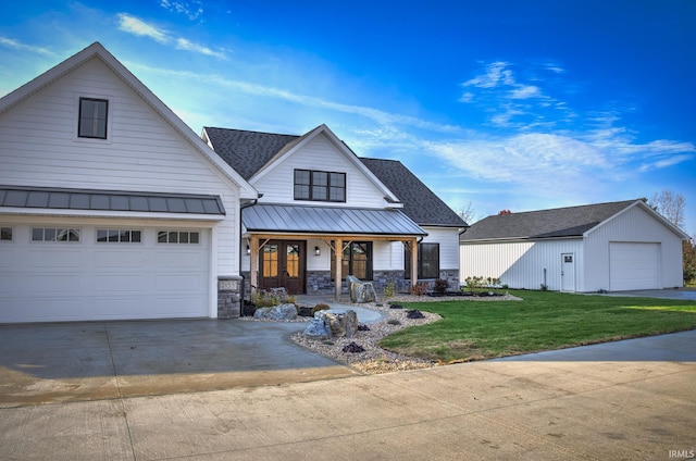 view of front facade featuring a porch, a garage, and a front lawn