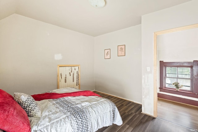 bedroom with dark wood-type flooring