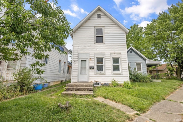 view of property featuring a front lawn