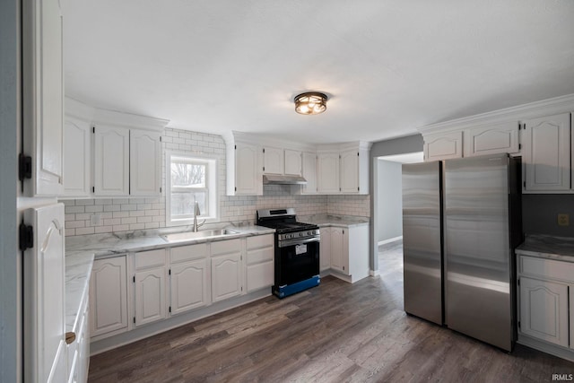 kitchen featuring sink, appliances with stainless steel finishes, dark hardwood / wood-style floors, tasteful backsplash, and white cabinets