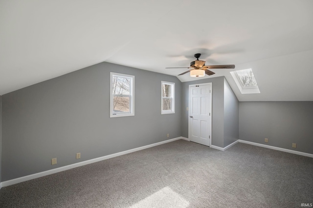 bonus room featuring ceiling fan, carpet flooring, and lofted ceiling with skylight