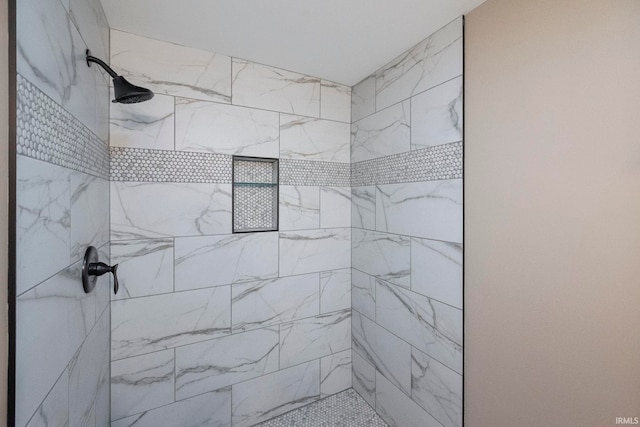 bathroom with tiled shower