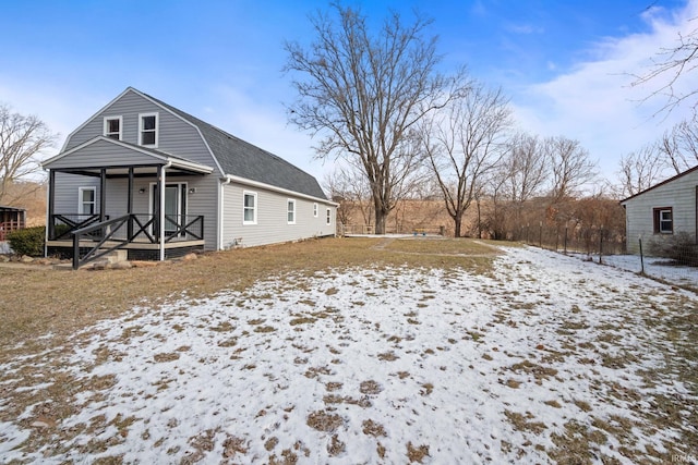 snow covered property featuring covered porch