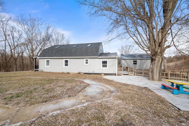 rear view of house featuring a patio area and a lawn