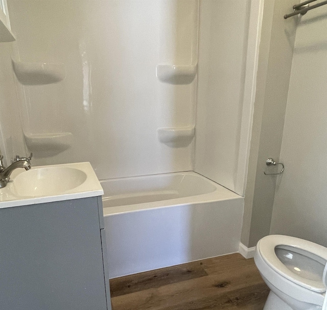 full bathroom with vanity, hardwood / wood-style floors, bathing tub / shower combination, and toilet