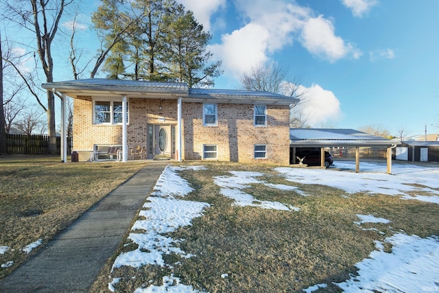 view of front of house featuring a carport and a yard