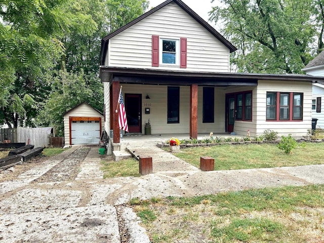 view of front of property featuring an outbuilding, a garage, a front yard, and covered porch