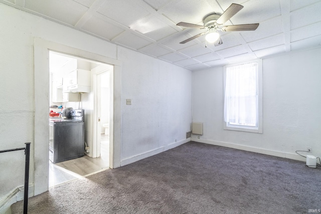 spare room with ceiling fan, carpet flooring, and washer / clothes dryer