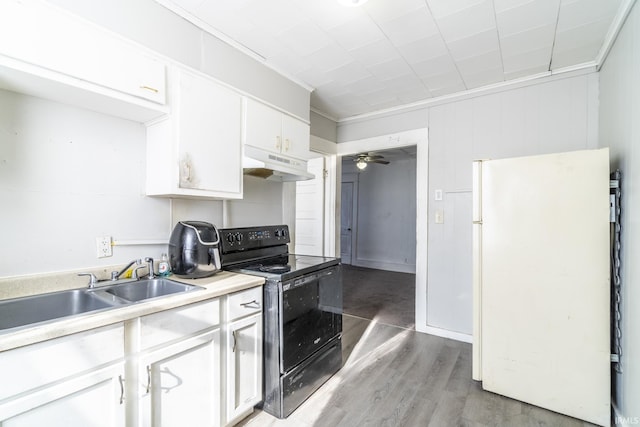 kitchen featuring black electric range oven, white cabinetry, ornamental molding, white fridge, and ceiling fan