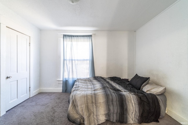 carpeted bedroom with a textured ceiling