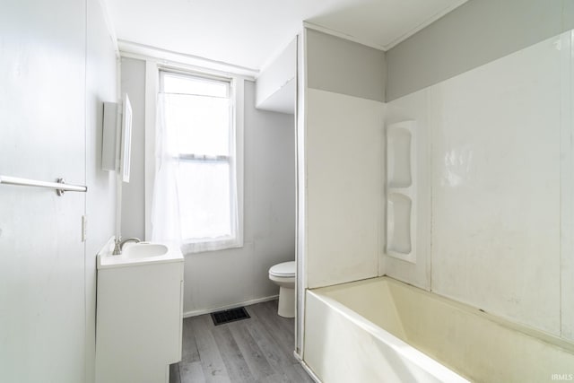 full bathroom featuring vanity, hardwood / wood-style flooring,  shower combination, and toilet