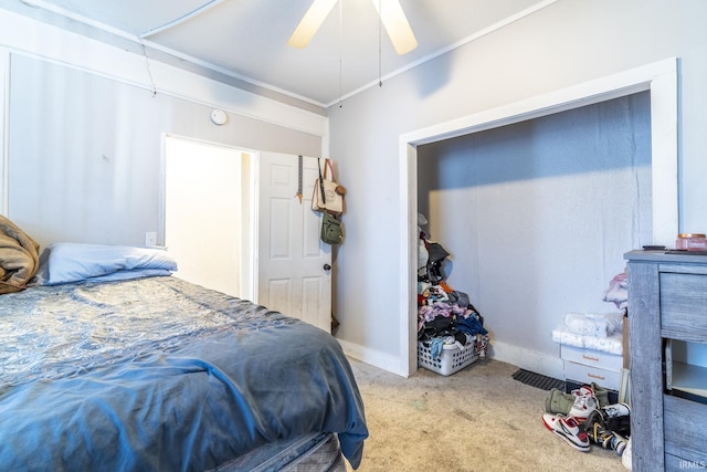 bedroom featuring ceiling fan, ornamental molding, and light colored carpet