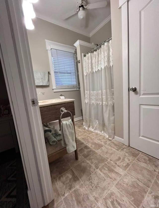 bathroom with ornamental molding, vanity, and ceiling fan