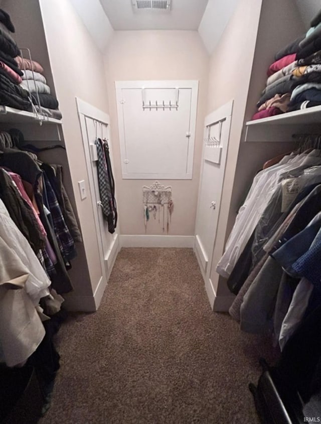 spacious closet with dark colored carpet