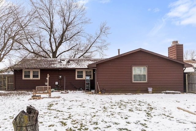 view of snow covered rear of property