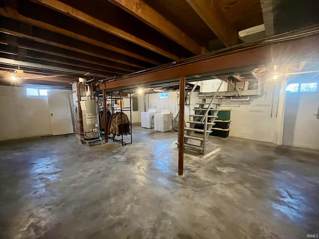 basement featuring gas water heater and washing machine and clothes dryer