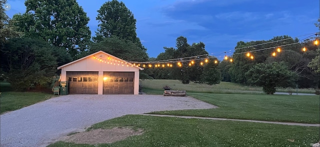 view of front of house featuring a garage, an outdoor structure, and a lawn