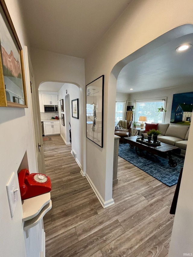 hallway with wood-type flooring