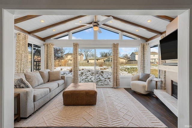 sunroom / solarium featuring vaulted ceiling with beams, wooden ceiling, and ceiling fan